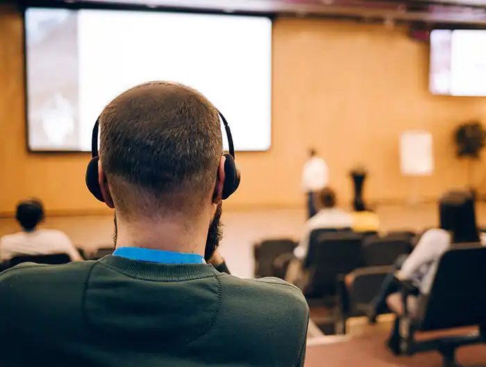 image business man is listen seminar at conference using headphones for translation
